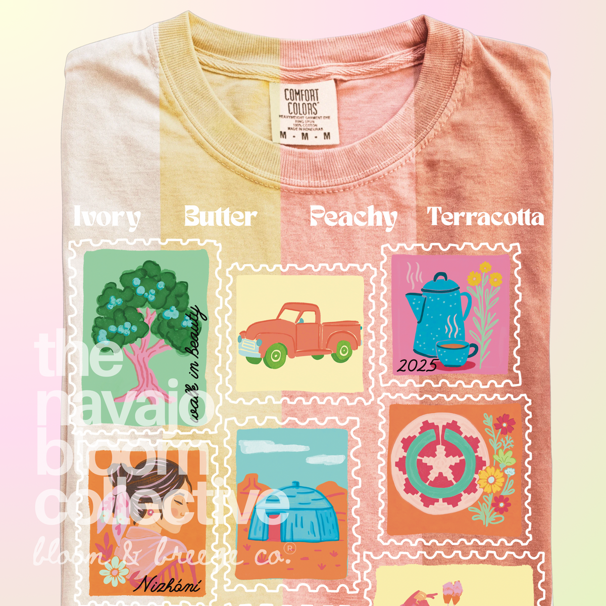 A folded graphic T-shirt shown against a soft pastel gradient background. The shirt has four color panels labeled 'Ivory', 'Butter', 'Peachy', and 'Terracotta' across the upper chest, with a large central multicolor Native American-inspired circular graphic and floral wreath.