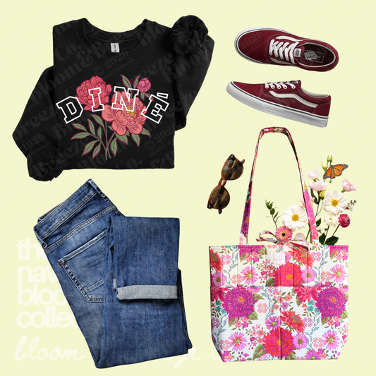 Black Diné floral sweatshirt styled with cuffed jeans, red sneakers, sunglasses, and a bright floral quilted tote bag.