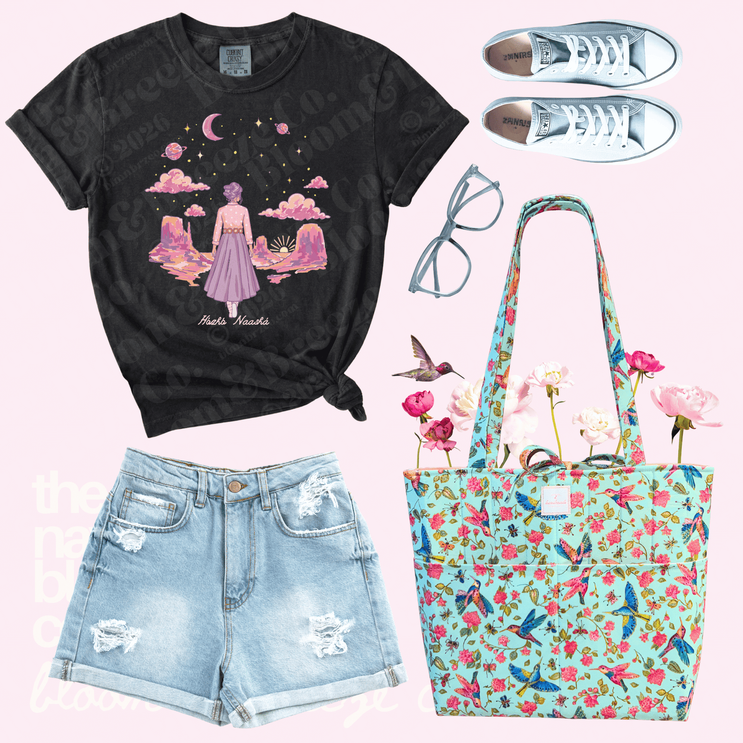 Black t-shirt with graphic design, denim shorts, floral tote bag, and sneakers on a pink background