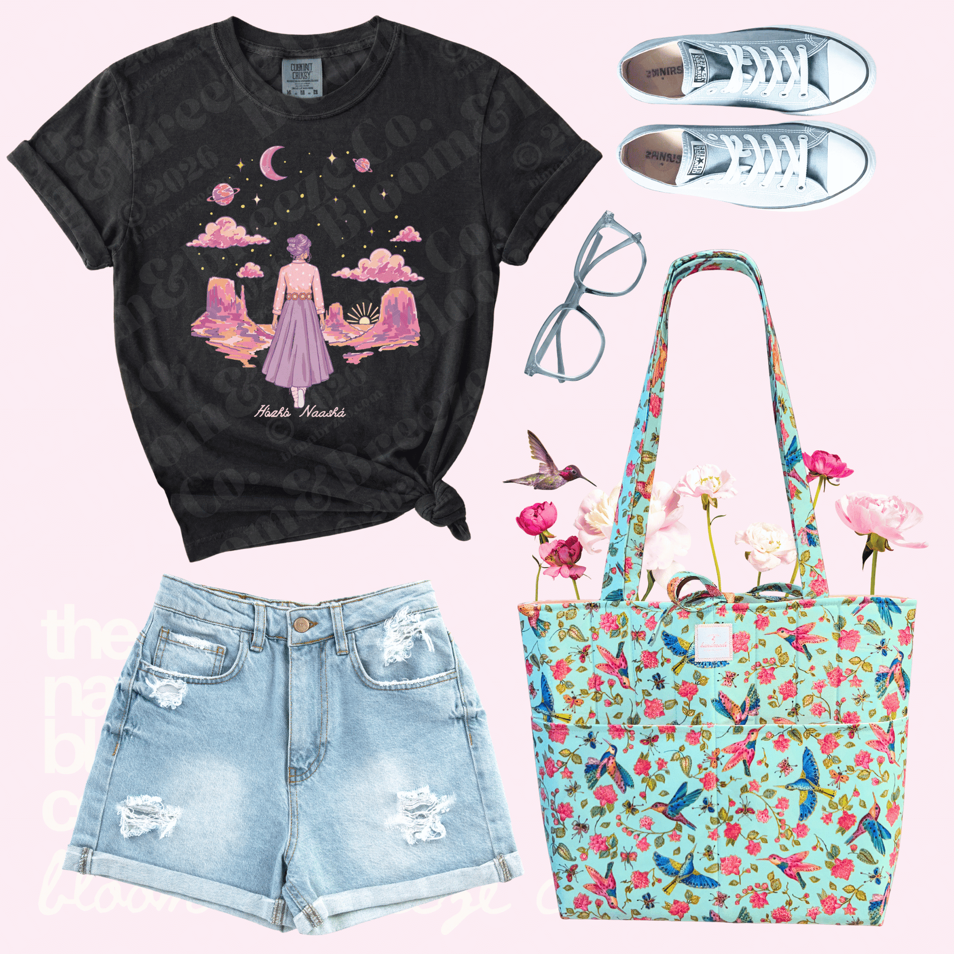 Black t-shirt with graphic design, denim shorts, floral tote bag, and sneakers on a pink background