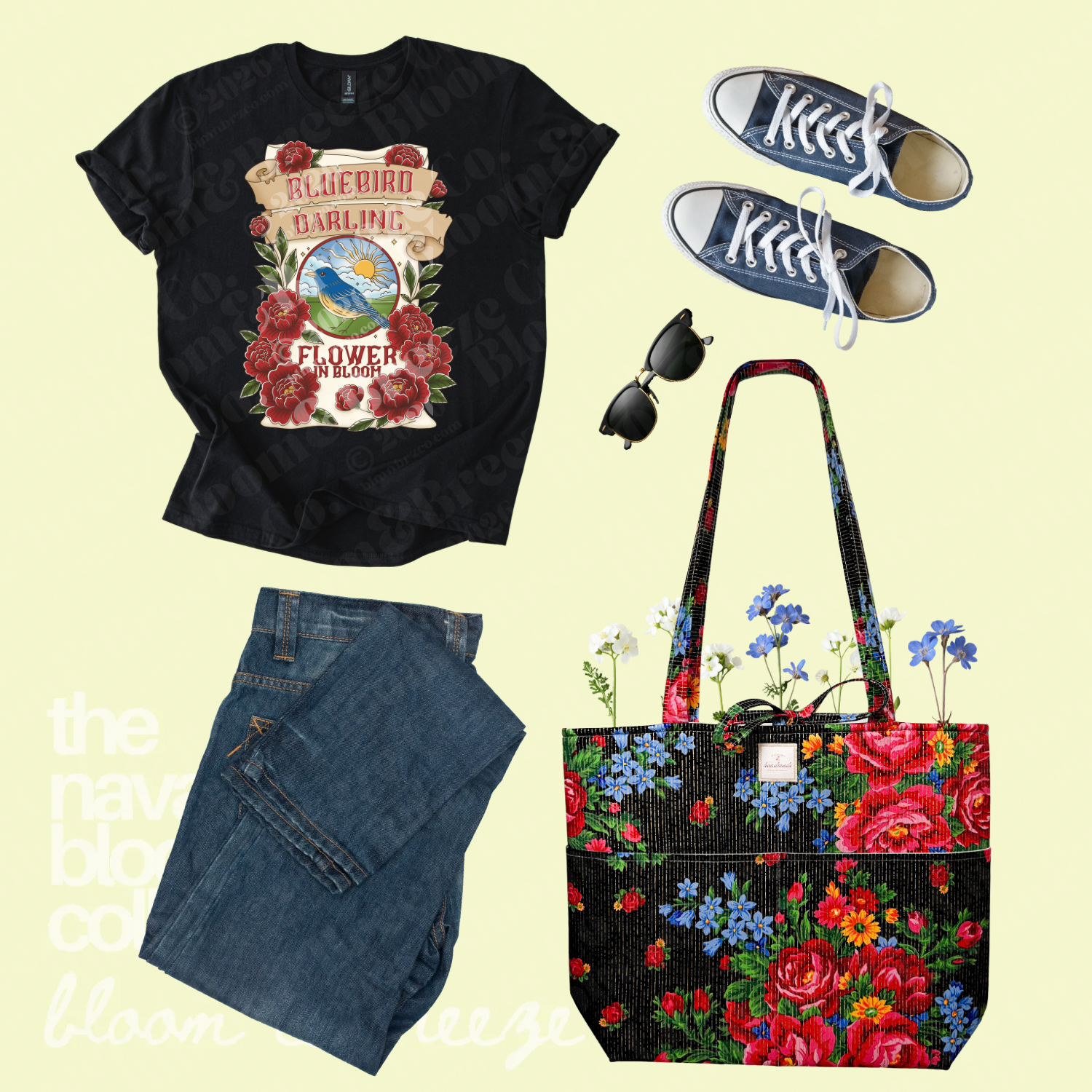 Black Bluebird Darling graphic tee styled with dark jeans, navy sneakers, sunglasses, and a black floral quilted tote bag.