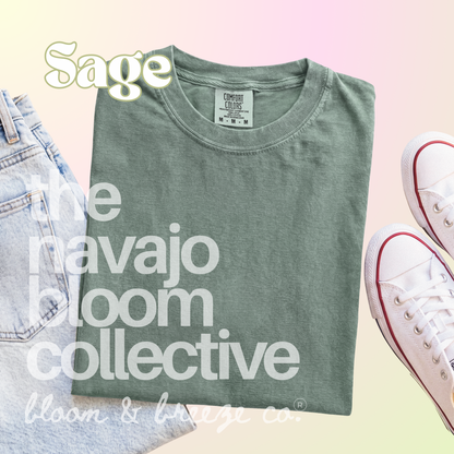 Sage green colored comfort colors flatlay with jeans and sneakers