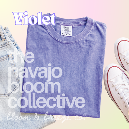 Violet colored comfort colors flatlay with jeans and sneakers