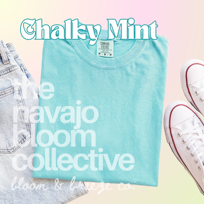 Neon aqua light colored comfort colors flatlay with jeans and sneakers