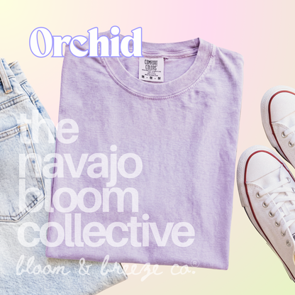 Light pastel purple colored comfort colors flatlay with jeans and sneakers