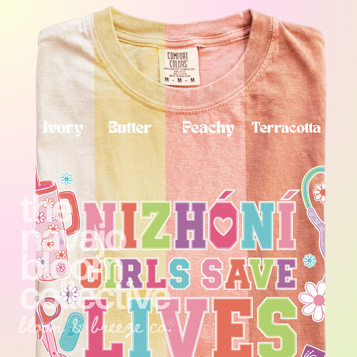 Nizhóní Girls Save Lives colorful lettering and medical-themed artwork on a Comfort Colors tee, comparing Ivory, Butter, Peachy, and Terracotta.