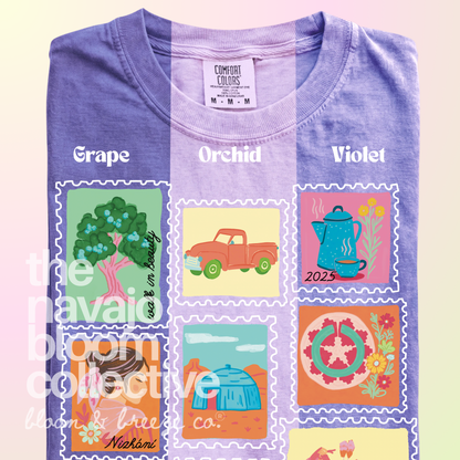 Dear Nizhóní stamp-style artwork on a folded Comfort Colors tee, comparing Grape, Orchid, and Violet.