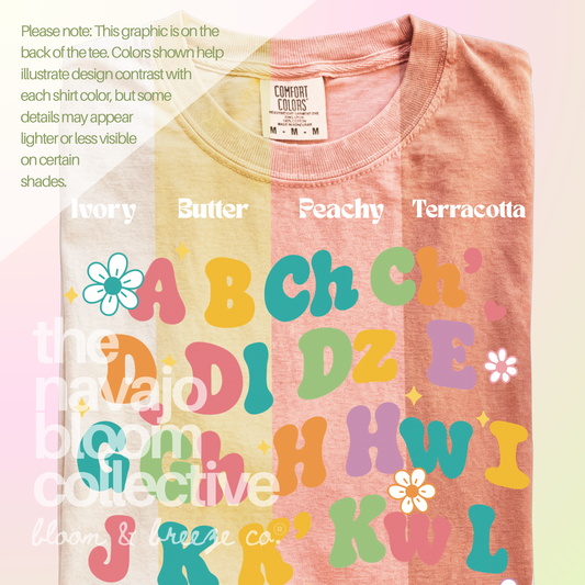 Yá’át’ééh Teacher colorful floral Navajo alphabet back design, comparing Ivory, Butter, Peachy, and Terracotta Comfort Colors tees.