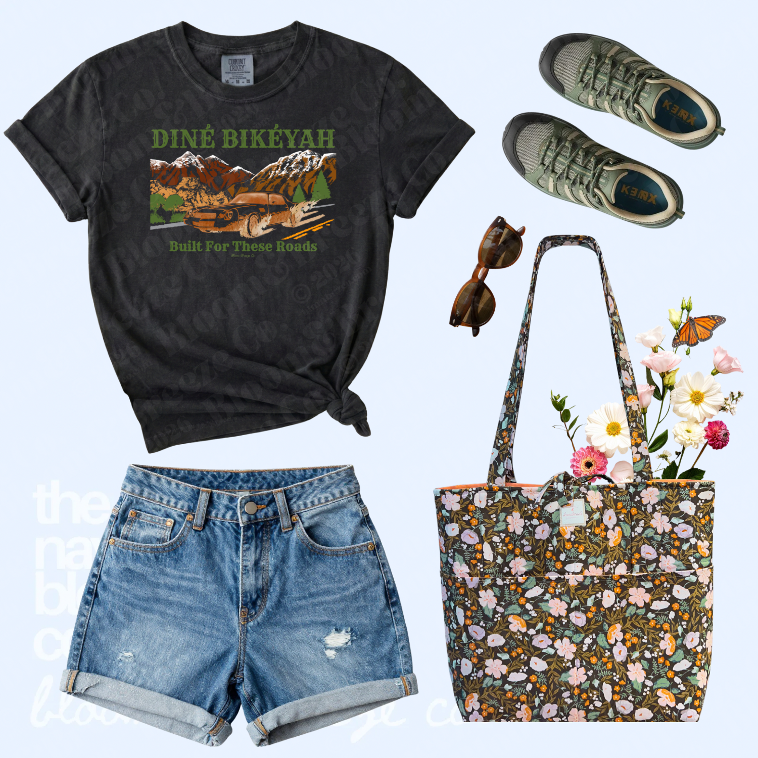 Black Diné Bikéyah graphic tee styled with denim shorts, green sneakers, sunglasses, and a dark floral quilted tote bag.