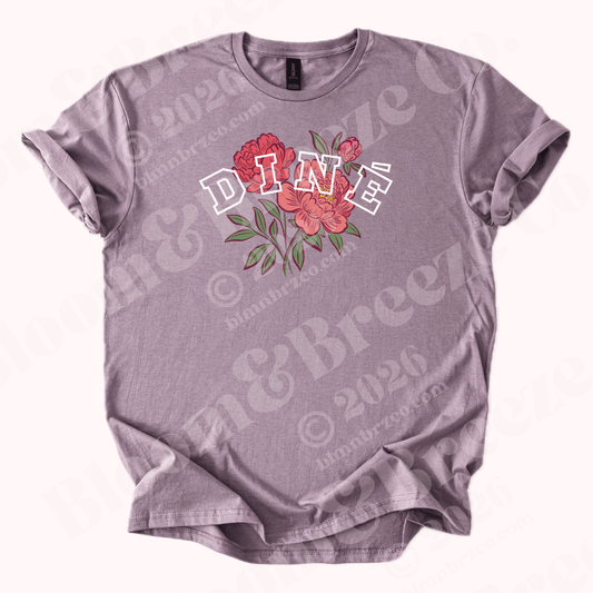 Light Purple t-shirt with floral design and text “Diné” on a white background