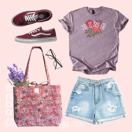 Lavender Diné floral graphic tee styled with denim shorts, red sneakers, black glasses, and a pink floral quilted tote bag.