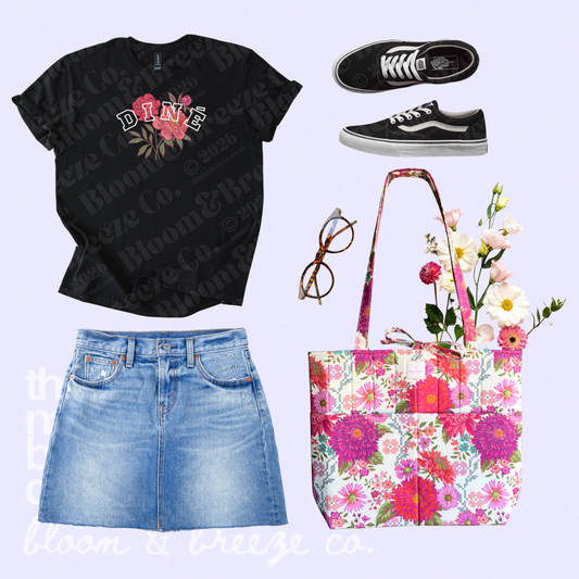 Black Diné floral graphic tee styled with a denim skirt, black sneakers, glasses, and a bright floral quilted tote bag