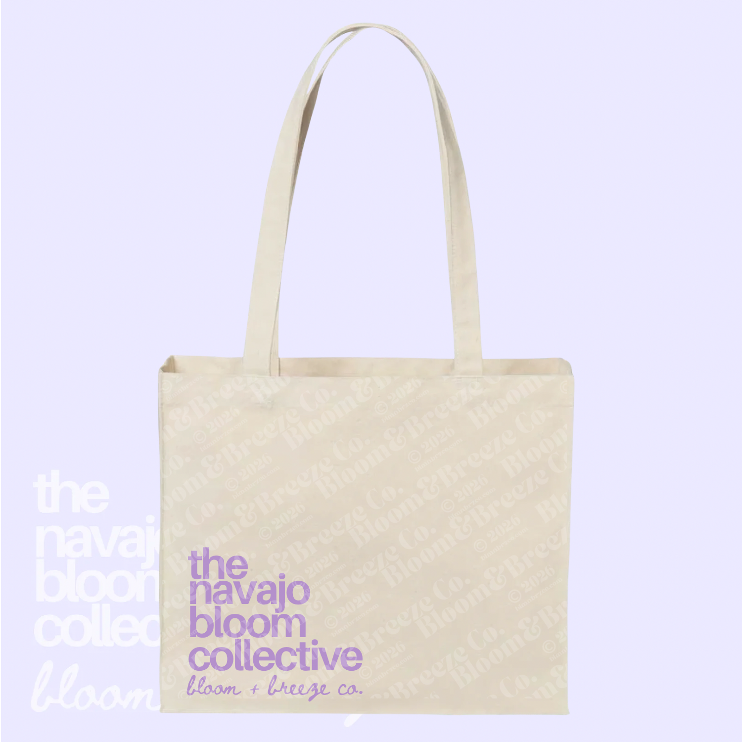 Beige tote bag with 'the navajo bloom collective' text on a light purple background