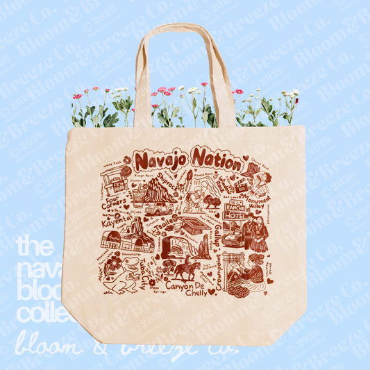 Cream canvas Navajo Nation tote bag with brown illustrated map-style artwork on a soft blue background.