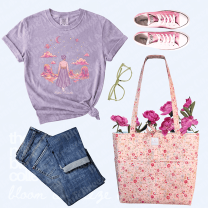 Purple t-shirt with graphic design, jeans, pink sneakers, glasses, floral tote bag, and flowers on a light purple background.