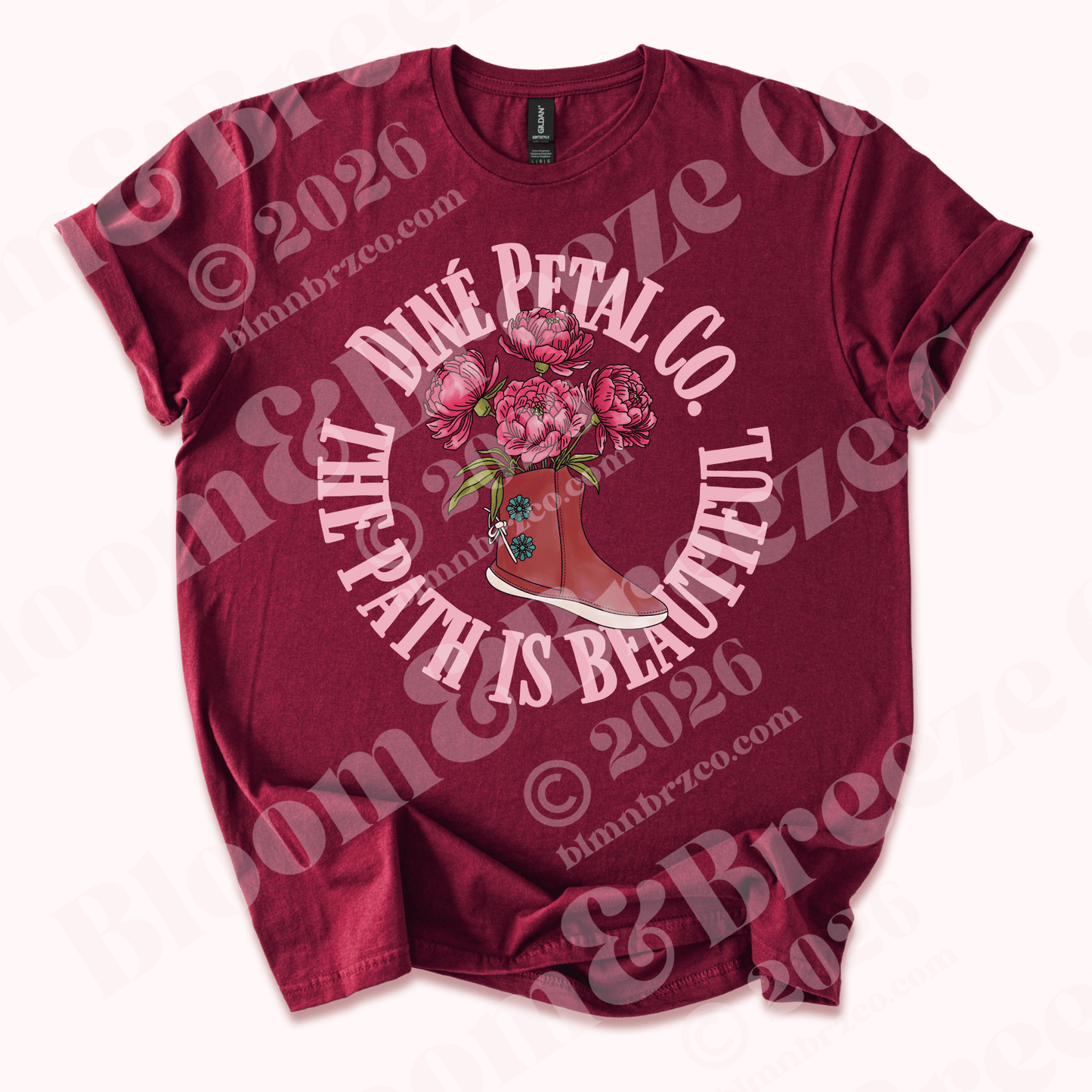 Maroon t-shirt with traditional navajo moccasin with peonies blooming from moccasin design and text reading Diné petal co, the path is beautiful on a white background