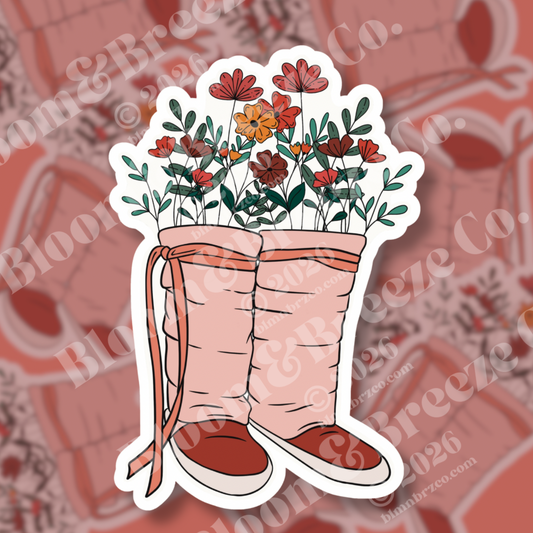 Soft pink Navajo wrap moccasins styled as flower vases, filled with wild desert blooms.