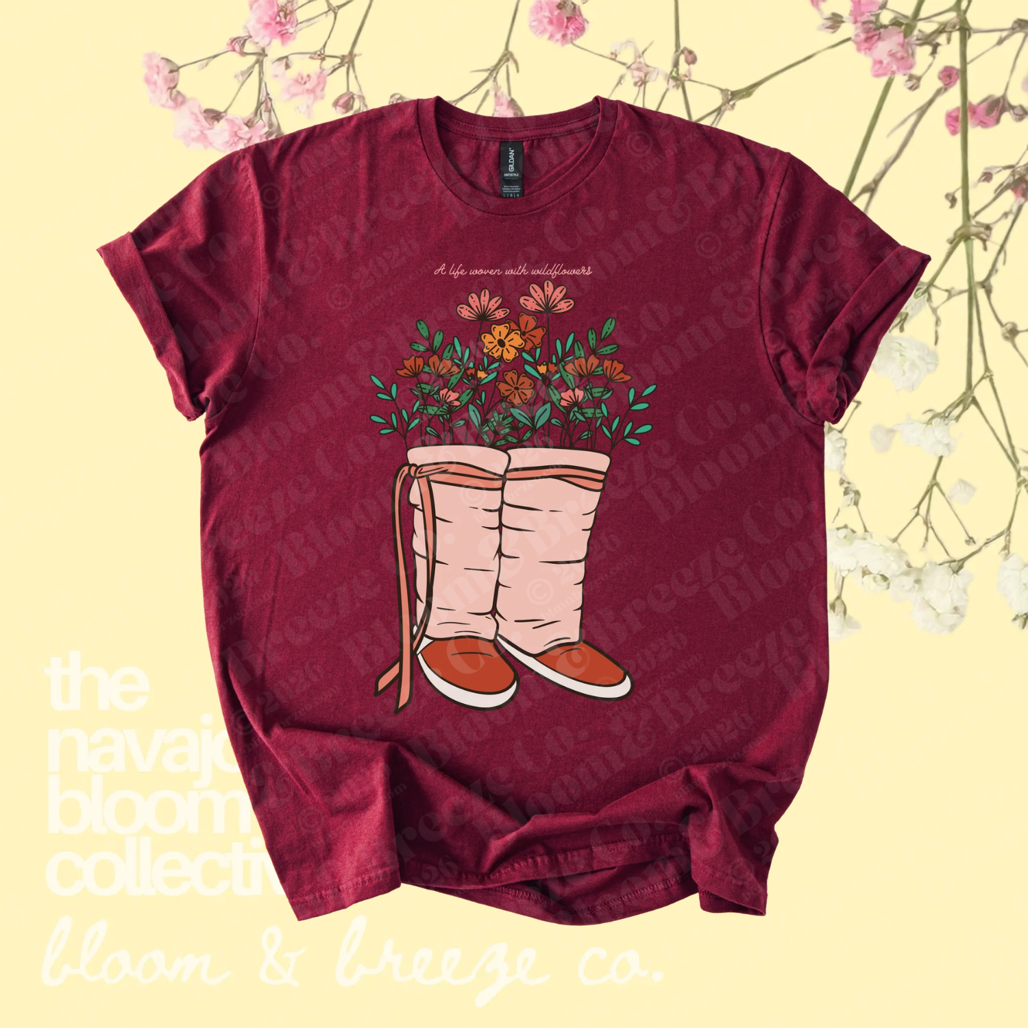Maroon wildflower moccasin graphic tee with “A life woven with wildflowers” text on a soft yellow floral background.