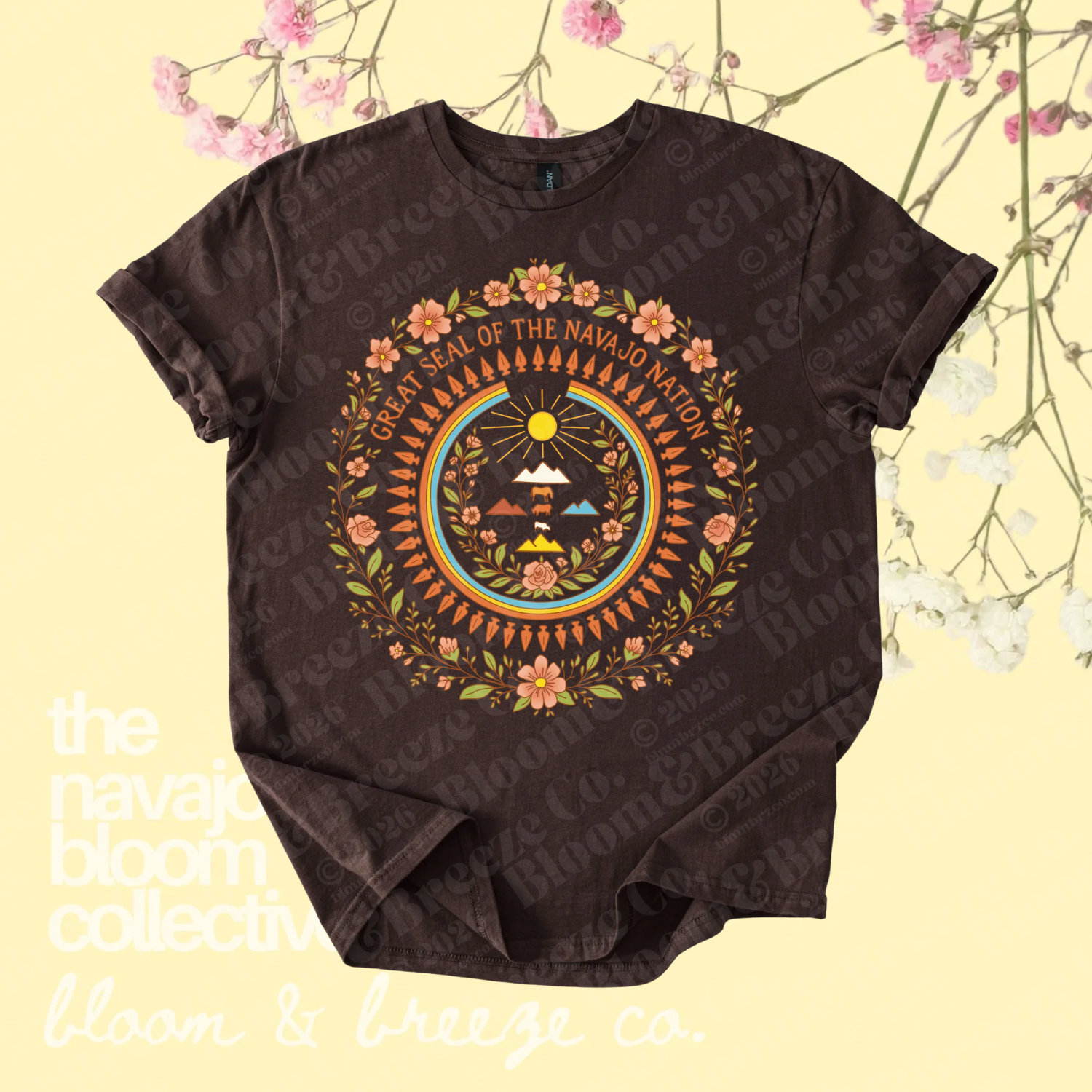 Brown Great Seal of the Navajo Nation graphic tee with floral details on a soft yellow floral background.
