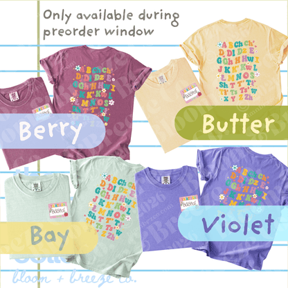 A collage showing multiple short-sleeve T-shirts in different colors with colorful alphabet graphics, labeled Berry, Butter, Bay, and Violet, with text stating 'Only available during preorder window' and a Bloom + Breeze Co. logo at the bottom.