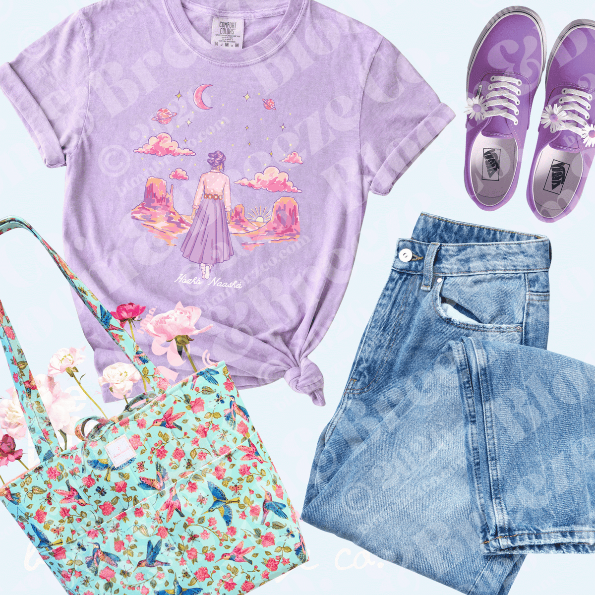 A styled flat-lay outfit featuring a lavender graphic t-shirt with a girl in a purple dress under a crescent moon, paired with light-wash denim shorts, purple sneakers, and a mint green floral tote bag on a light blue background.