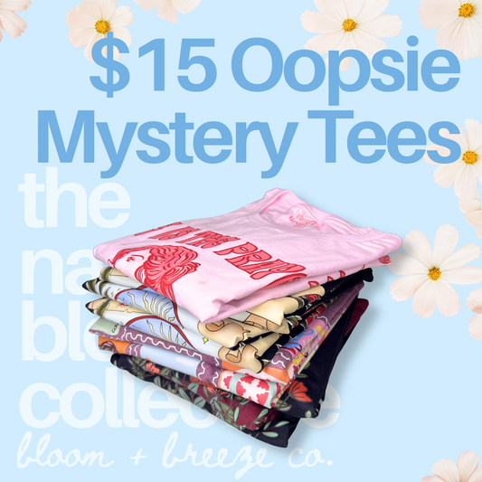 Stack of colorful t-shirts with text about $15 Oopsie Mystery Tees on a light blue background with flowers.