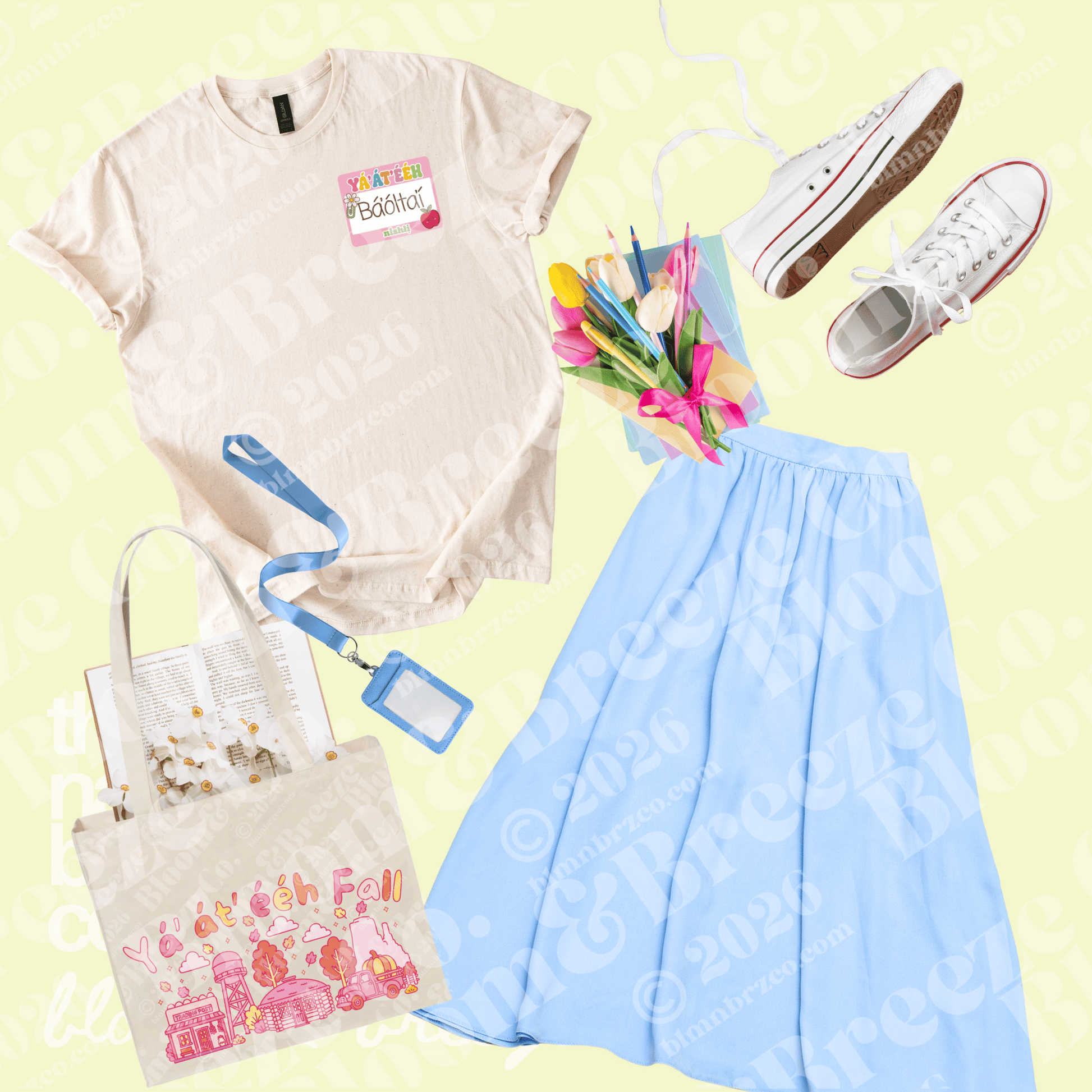 A flat-lay outfit arrangement on a pale yellow background featuring a cream graphic T-shirt, a light blue pleated skirt, white sneakers, a tote bag with pink illustrations, a blue ID badge, and a small bouquet of tulips.