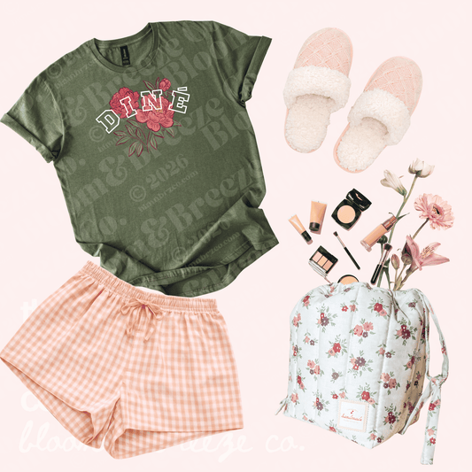 Green shirt pink pajama bottoms with makeup bag and slippers flat lay