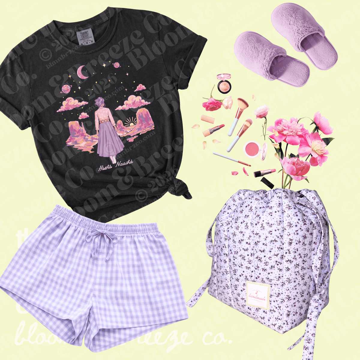 A flat-lay outfit set featuring a black graphic t-shirt with a pastel fantasy illustration, lavender gingham shorts, lavender slip-on slippers, and a matching lavender floral backpack, arranged on a pale yellow background with cosmetic props.