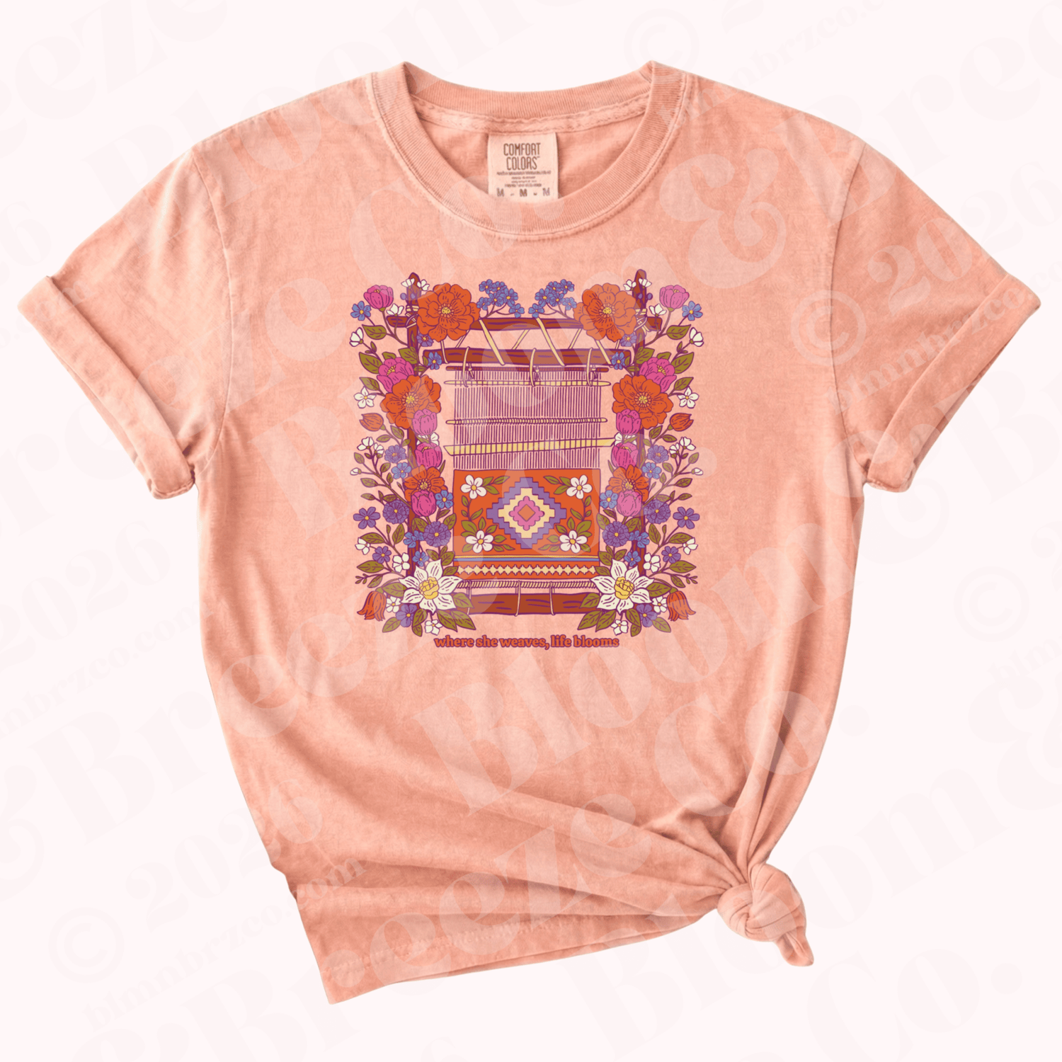 Comfort colors peachy t-shirt with a floral colorful navajo loom graphic design on a white background