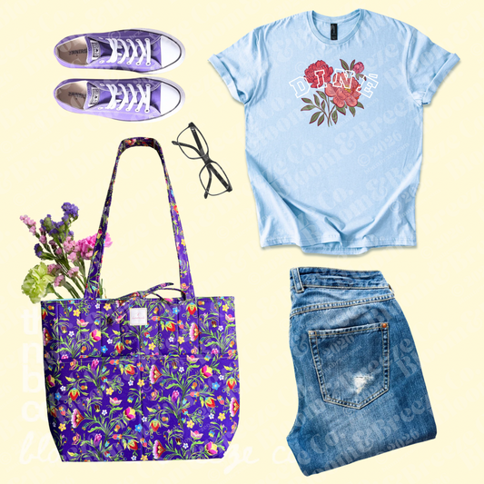 light blue shirt with purple quilted tote bag, denim jeans and purple sneakers flat lay