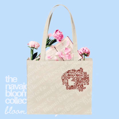 Cream canvas Navajo Nation tote bag with brown illustrated map-style artwork on a soft blue background.