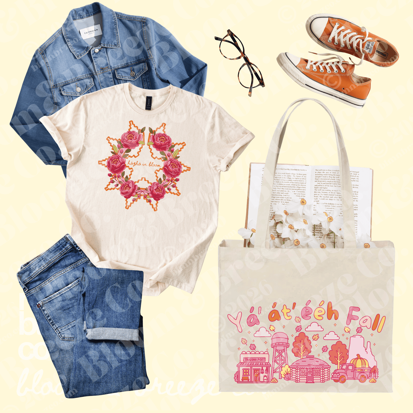 A flat-lay outfit arrangement on a pale yellow background featuring a cream graphic T-shirt with a pink rose wreath design, a blue denim jacket, blue jeans, orange sneakers, eyeglasses, and a cream tote bag with pink fall-themed illustrations and the text 'y'all at ech fall.'.