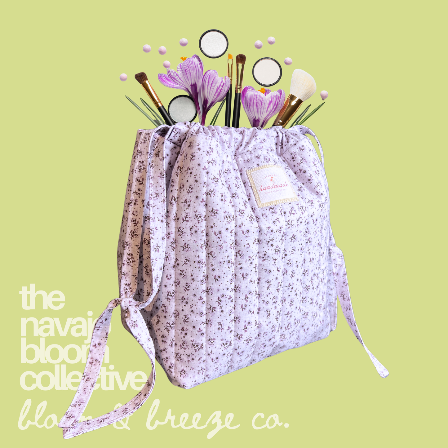 Lavender floral Petal Pouch filled with makeup brushes, flowers, and beauty items on a light green background with Bloom & Breeze Co. branding.